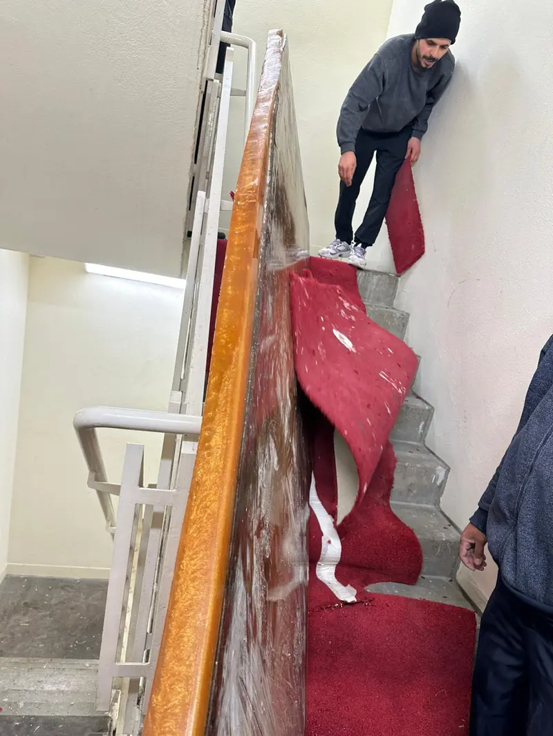 London Moverz team carefully carrying furniture upstairs
