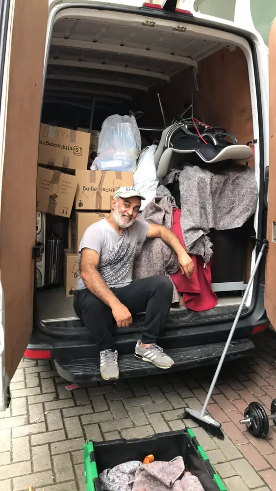 Ali and colleague on the van step after a job