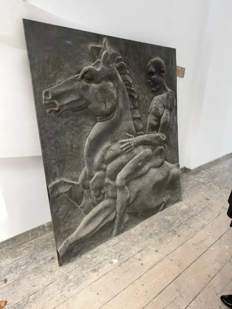 Large bronze relief panel delivered and placed against the wall