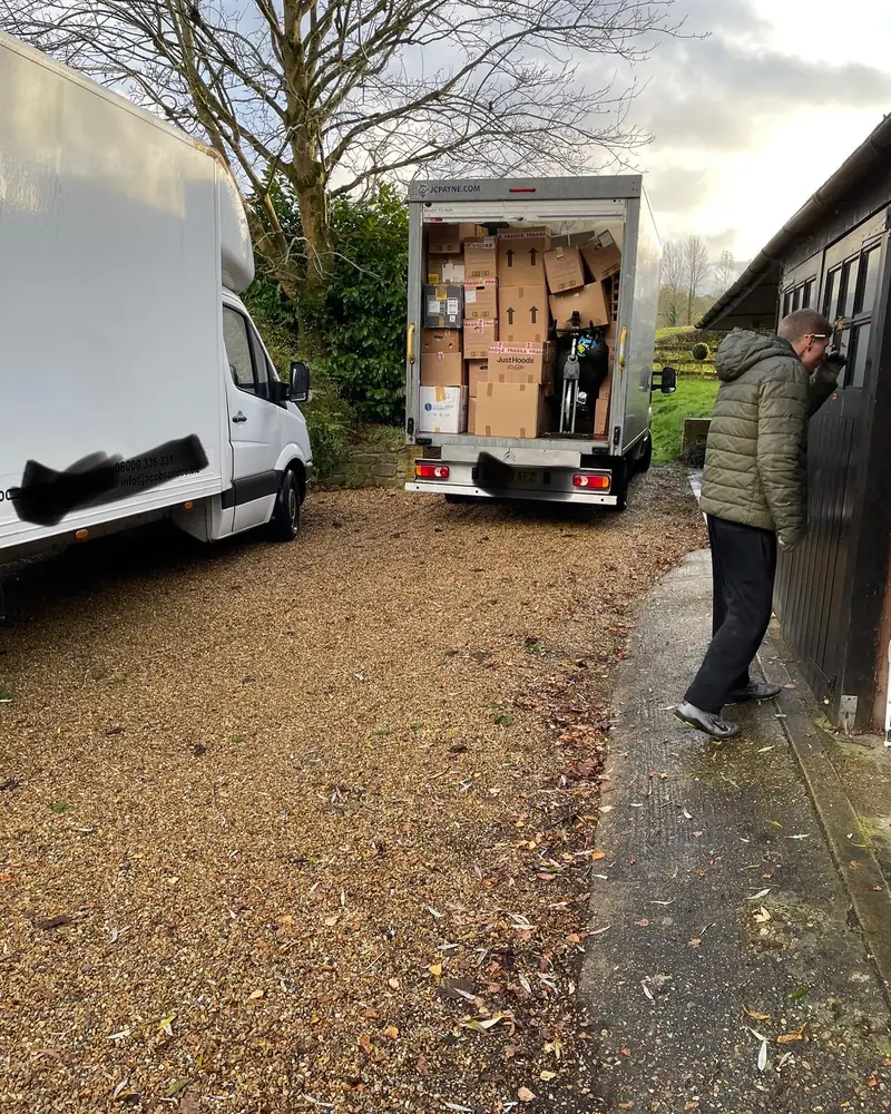 Loading the Luton van outside a house