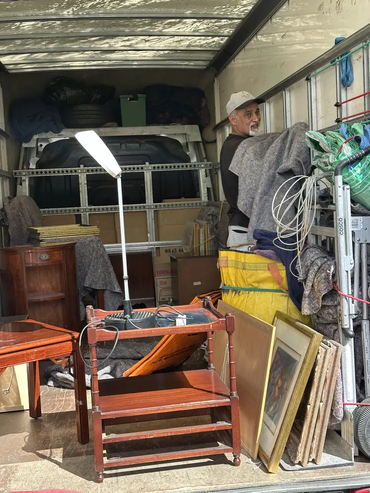 Furniture, lamps and framed pictures loaded in the van