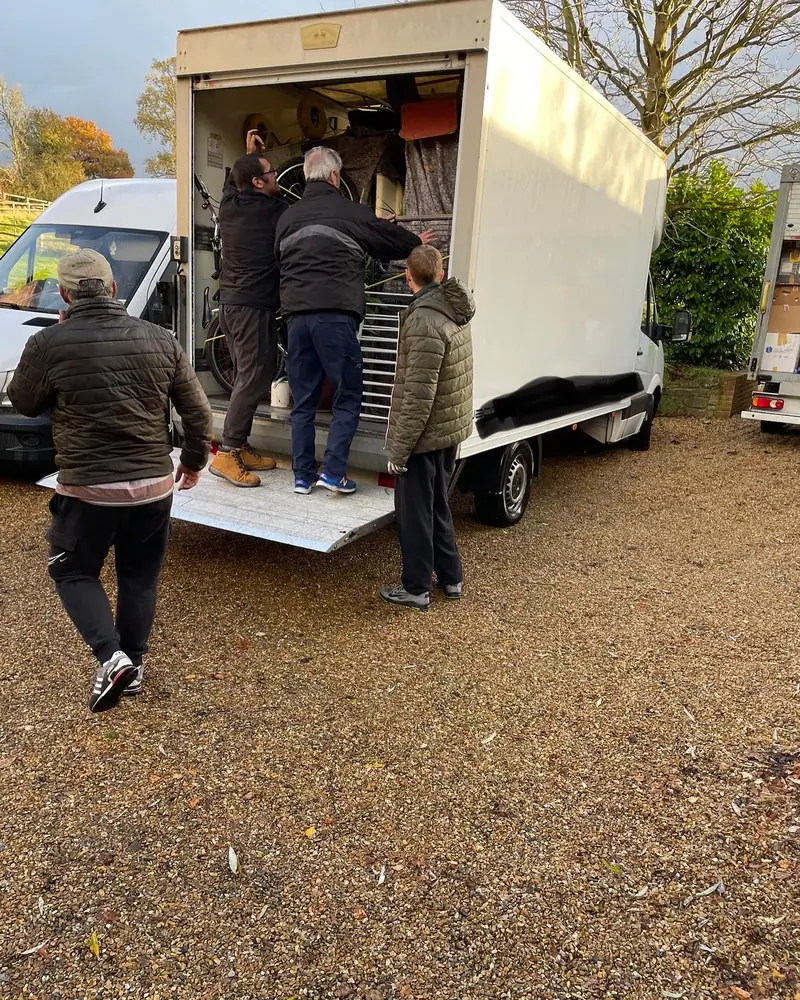 Team loading the Luton van on a gravel drive