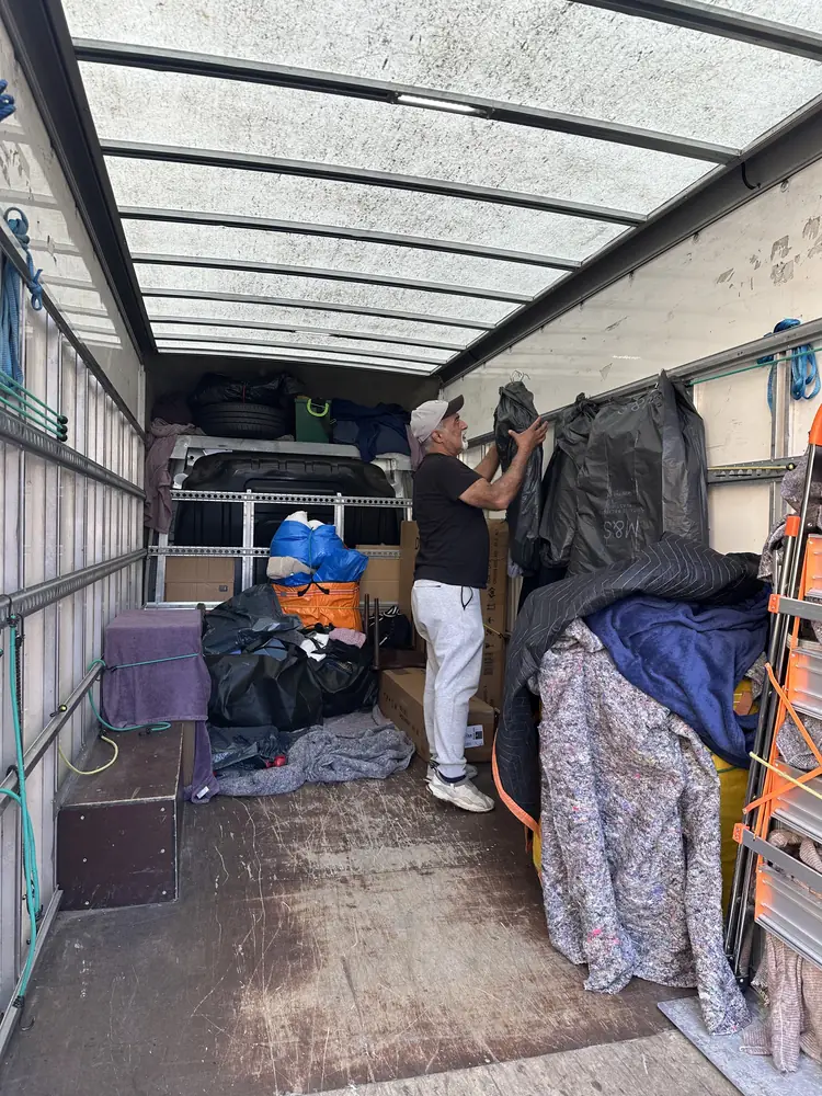 Two-man team loading the Luton van