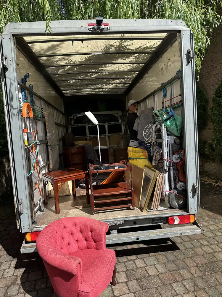 Pink armchair and dining furniture loaded in the Luton