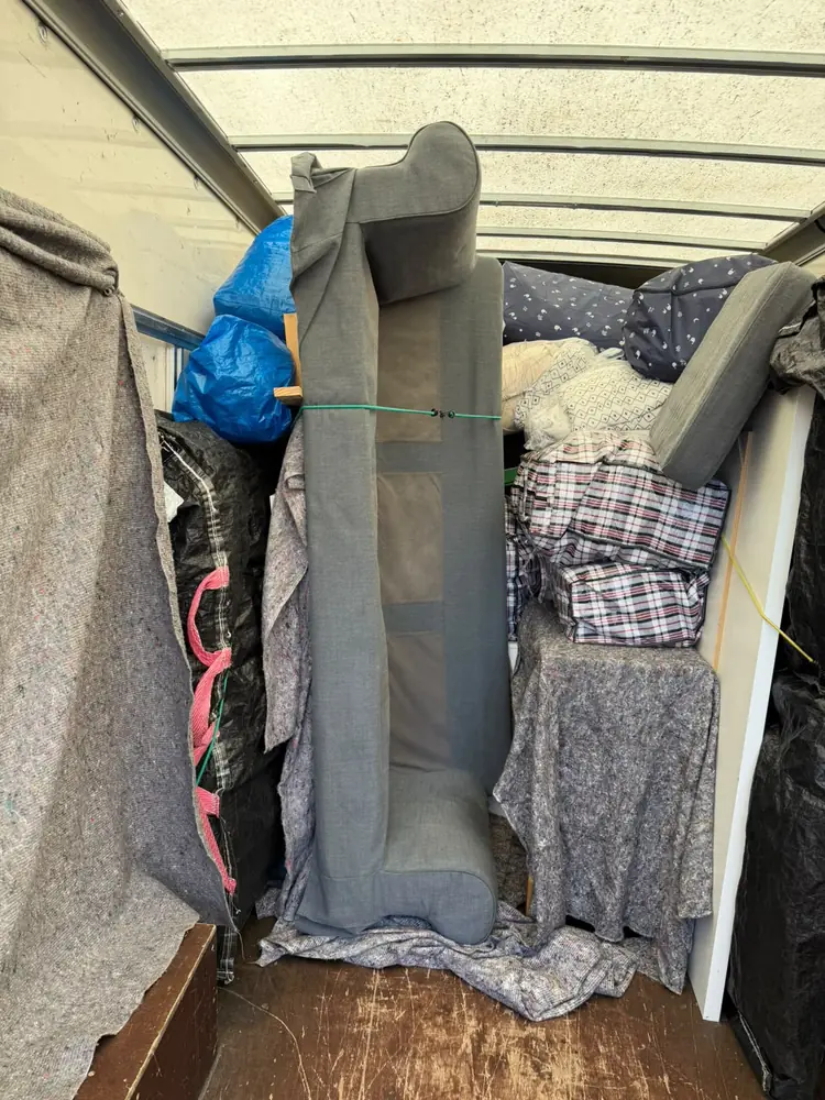 Sofa loaded upright and strapped in the Luton van