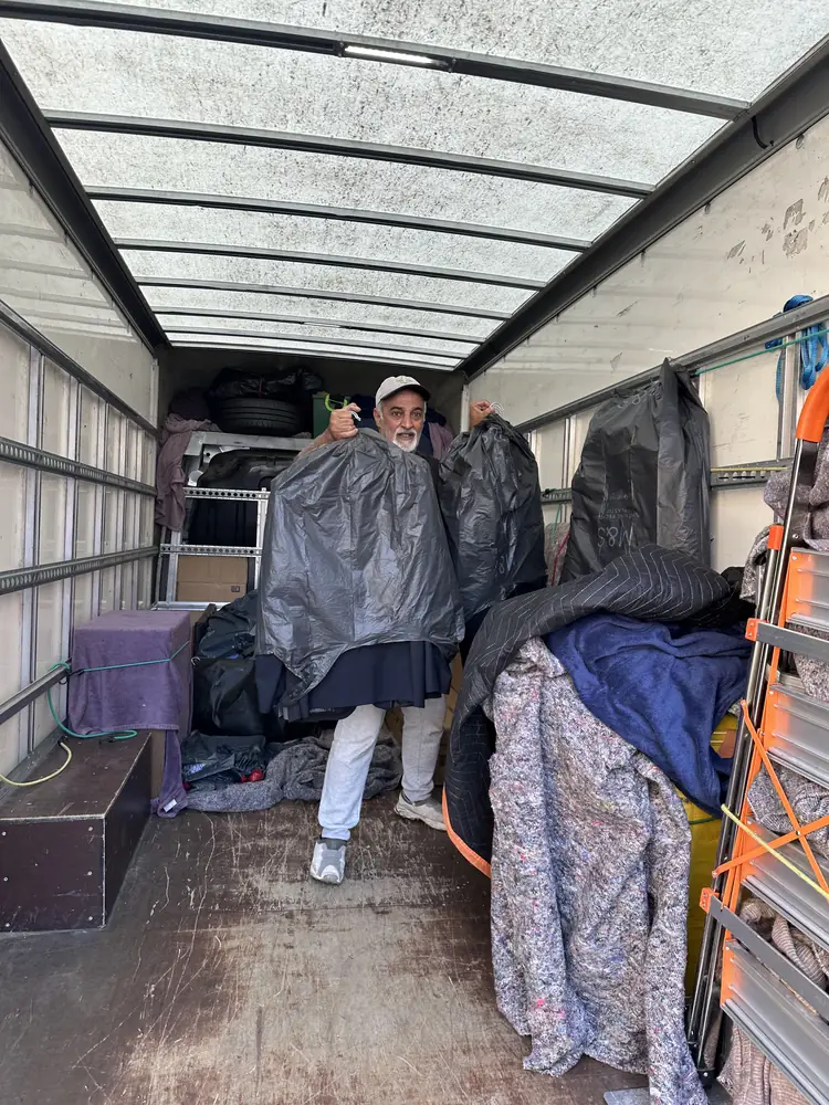 Blanket-wrapped furniture loaded and strapped