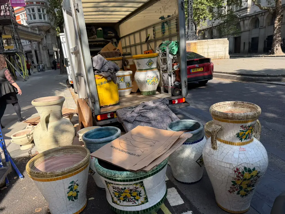 Mosaic ceramic planters being unloaded from the van on a Marylebone street, central London