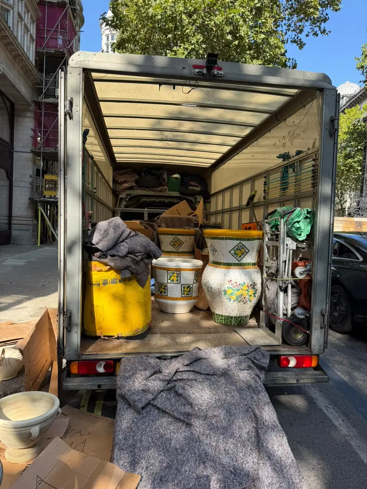 Ceramic planters wrapped in blankets in the back of the Luton van, Marylebone delivery