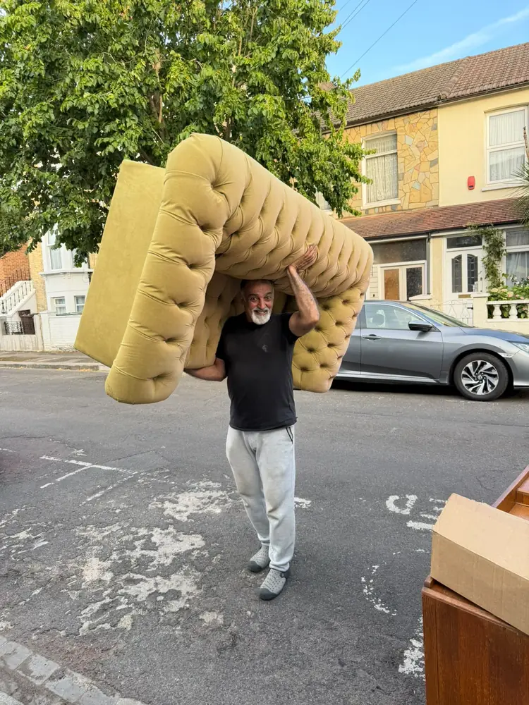 Carrying a sofa on a residential street