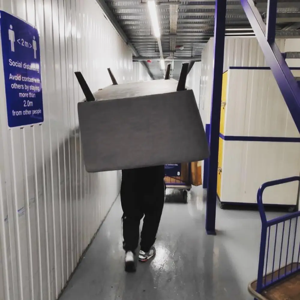 Carrying a table into a storage unit