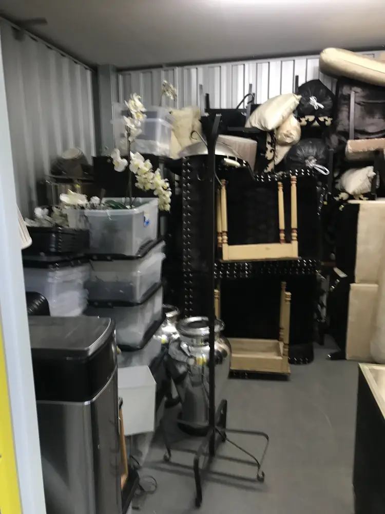 Self-storage unit packed with furniture and boxes