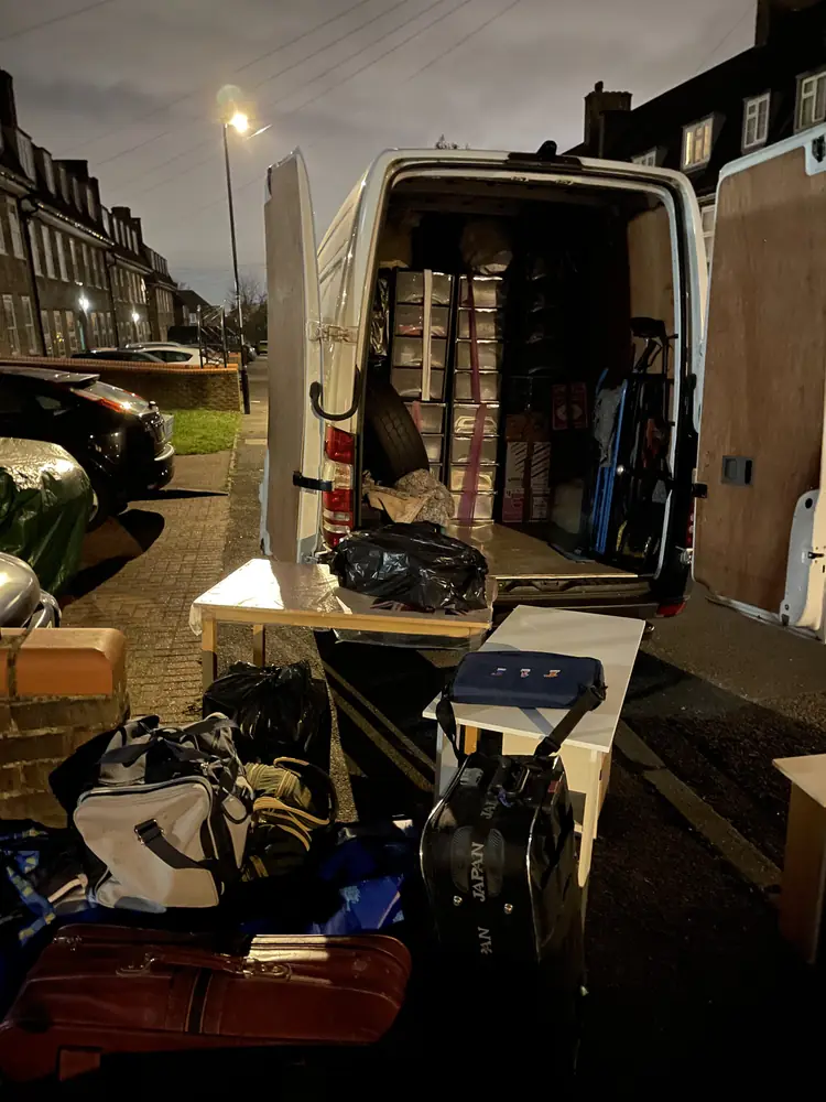 Loading the van on a residential street at dusk