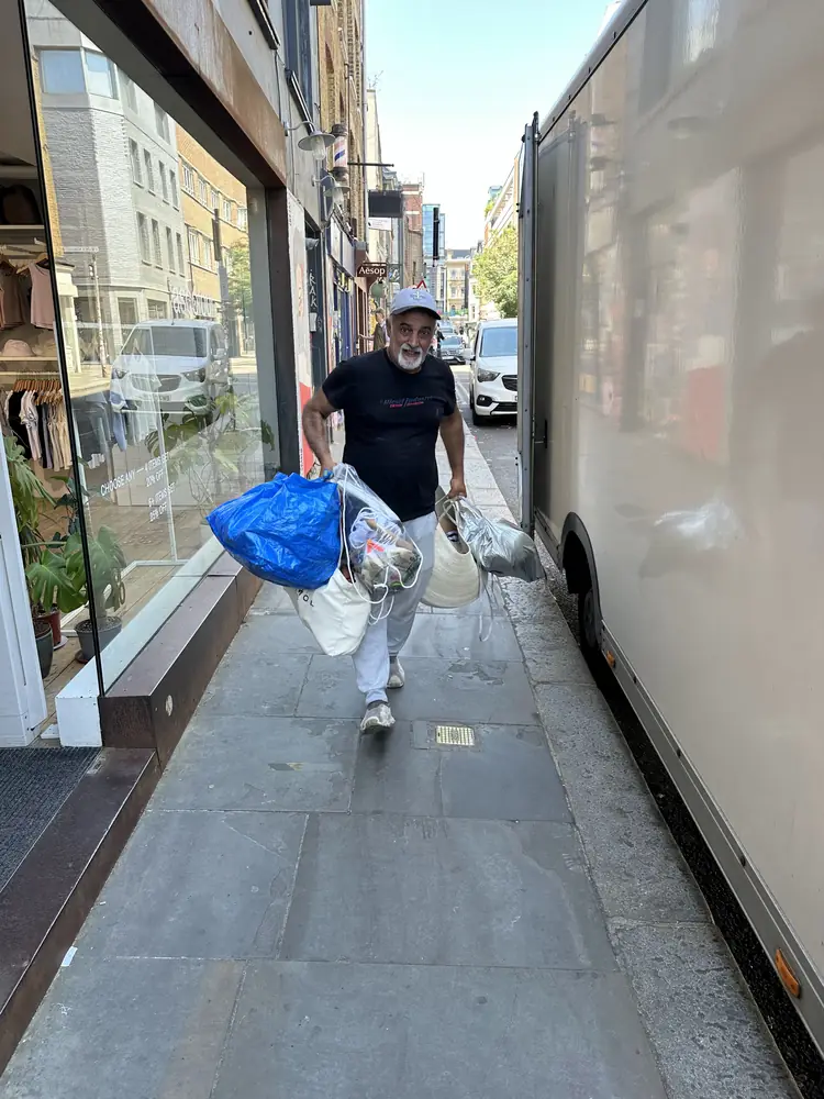 Team carrying bags along a London street