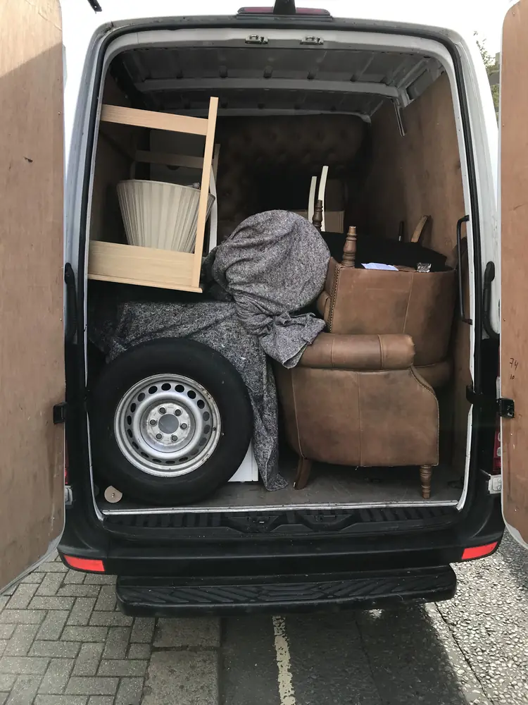 Sofa and bed frame loaded, doors open, ready to go